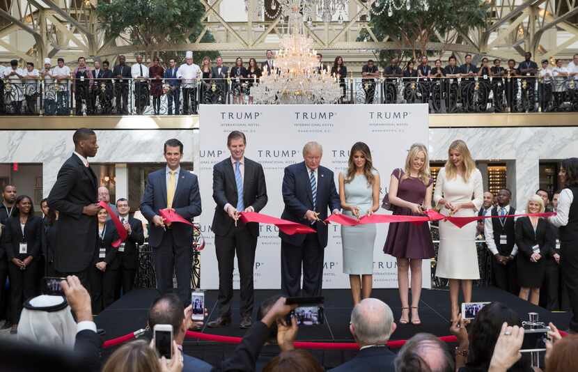 President Donald Trump cut the ribbon with his wife and children during an event celebrating...