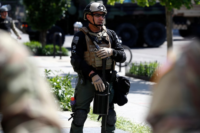 An officer from the Bureau of Prisons special operations response team carries a...