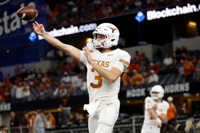 Texas Longhorns quarterback Quinn Ewers (3) warms up his arms during pregame workout before...