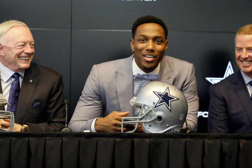 Dallas Cowboys No. 1 draft pick defensive end Taco Charlton, center, speaks to reporters...