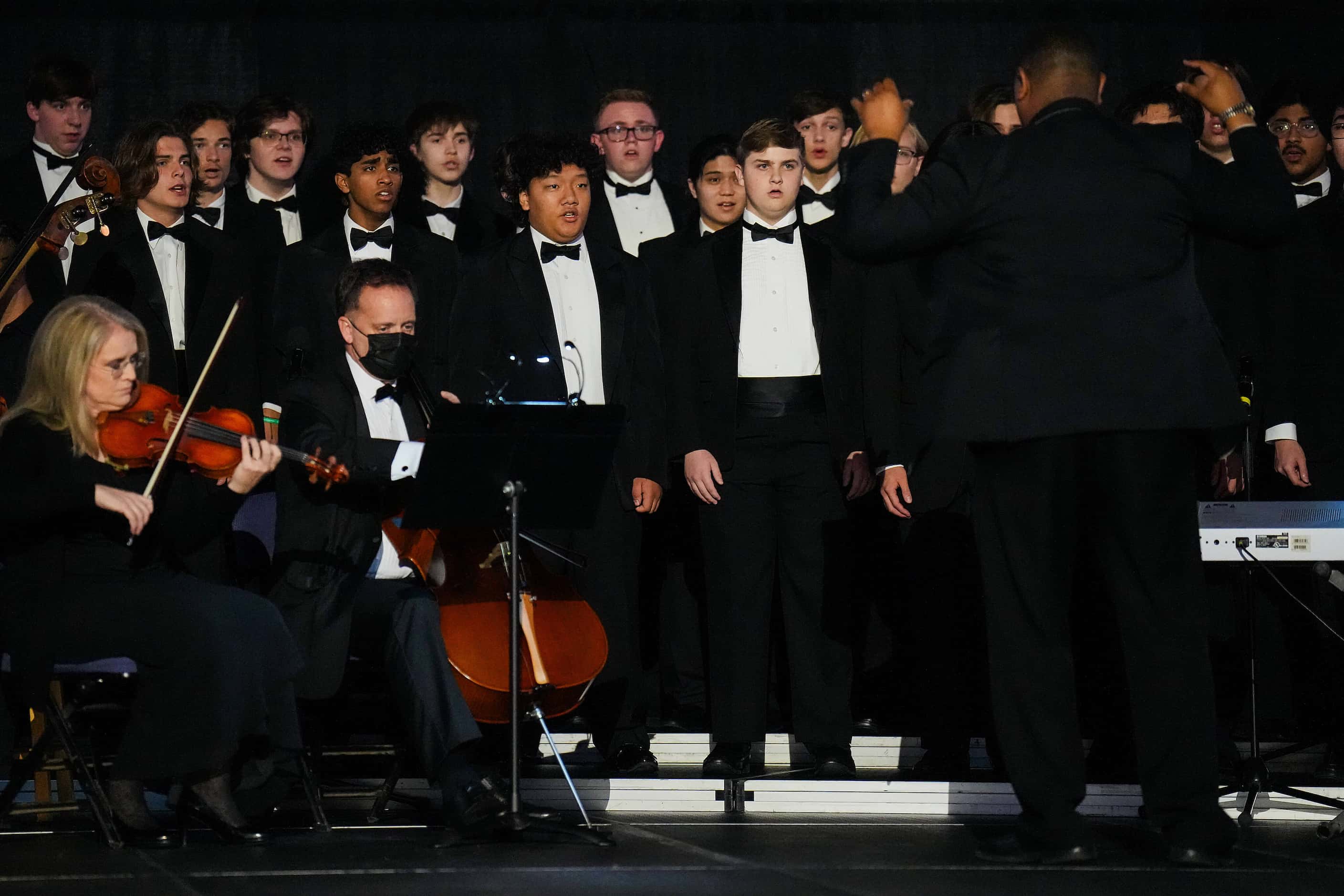 The Allen High School Varsity Men’s Choir sings “Amazing Grace” during a remembrance event...