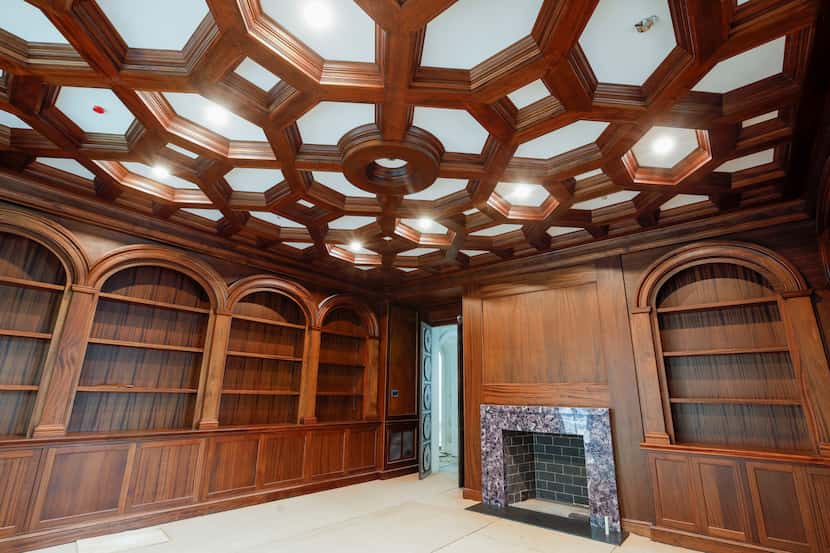 The library at 6915 Baltimore Drive has African mahogany-lined walls and bookshelves and an...