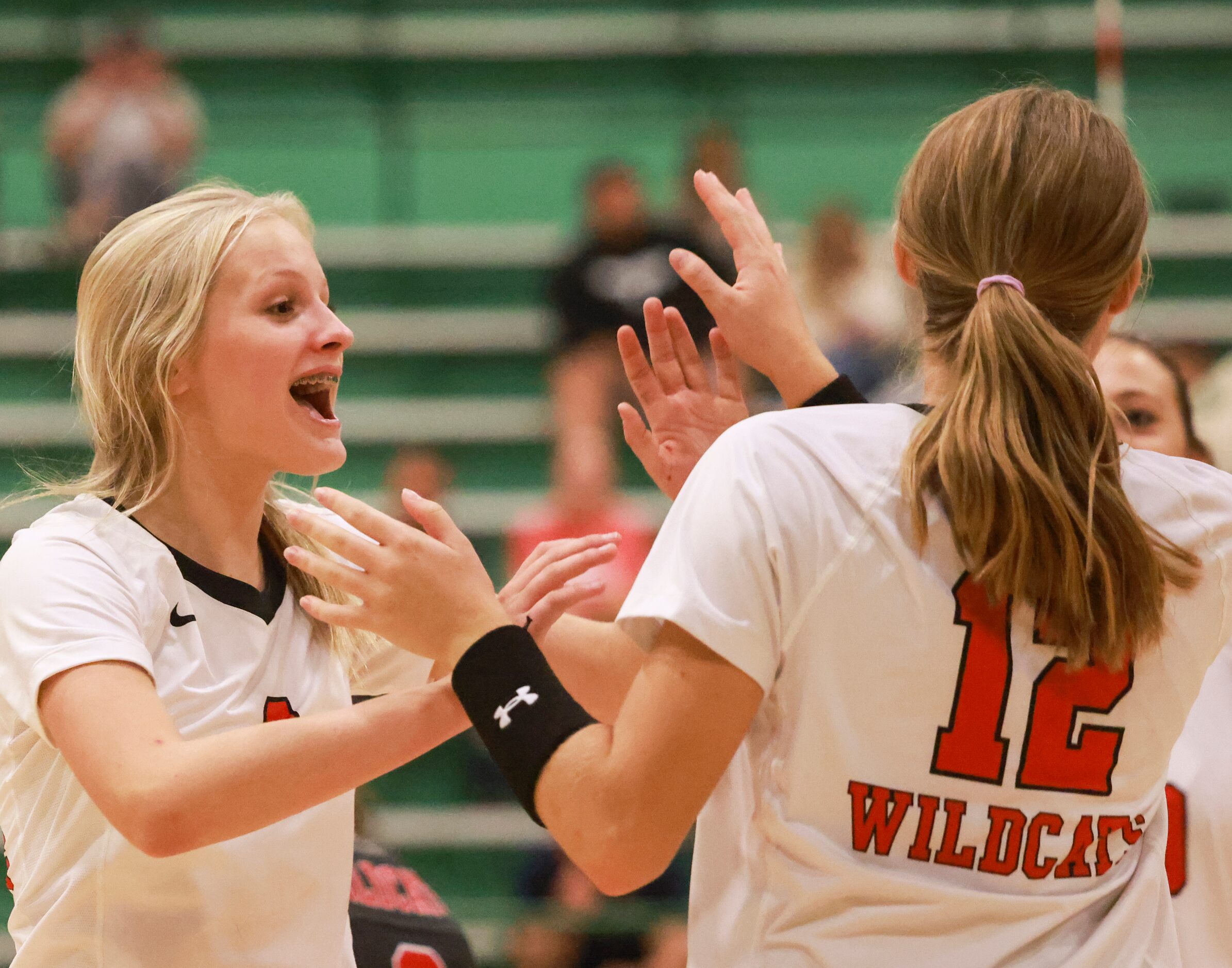 Lake Highlands High School Miller McDonald (2) high fives Haley Pokorski (12) after she...