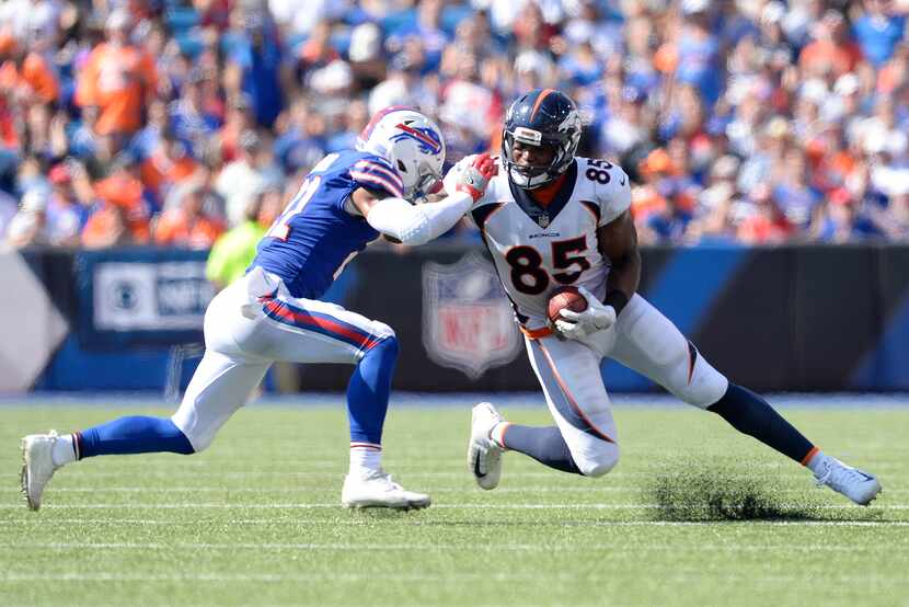 Buffalo Bills free safety Jordan Poyer, left, makes a hit on Denver Broncos tight end Virgil...