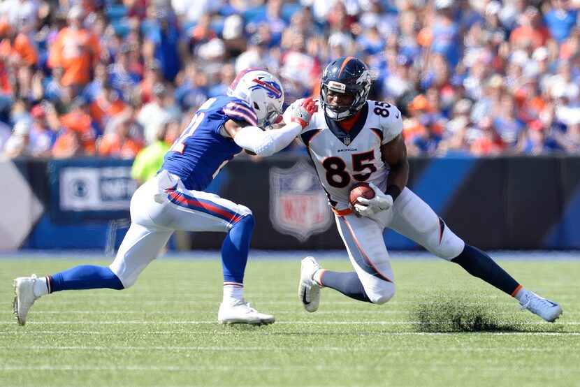 Buffalo Bills free safety Jordan Poyer, left, makes a hit on Denver Broncos tight end Virgil...