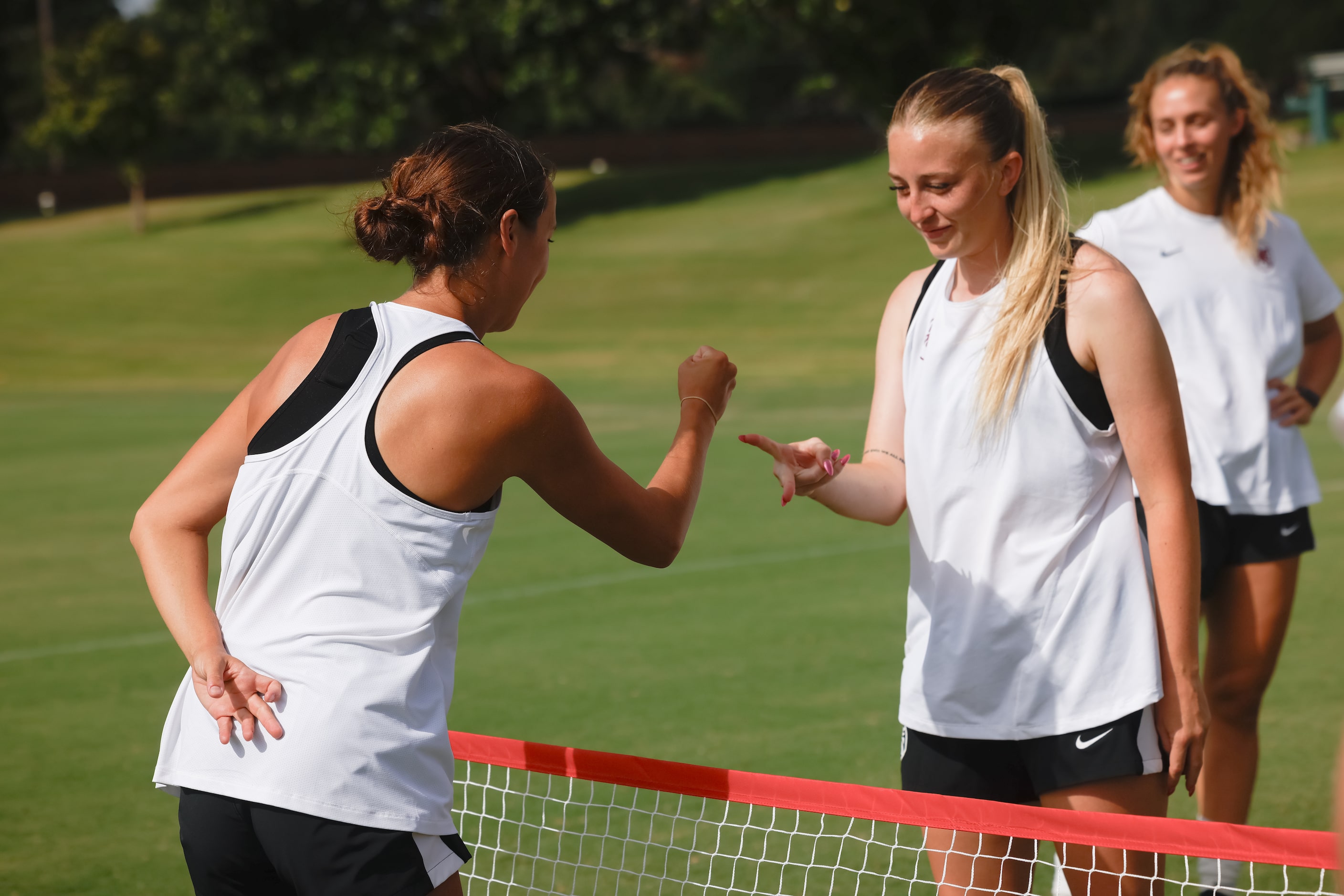 From left, Dallas Trinity FC players Gracie Bryan and Haley Berg do rock-paper-scissors to...