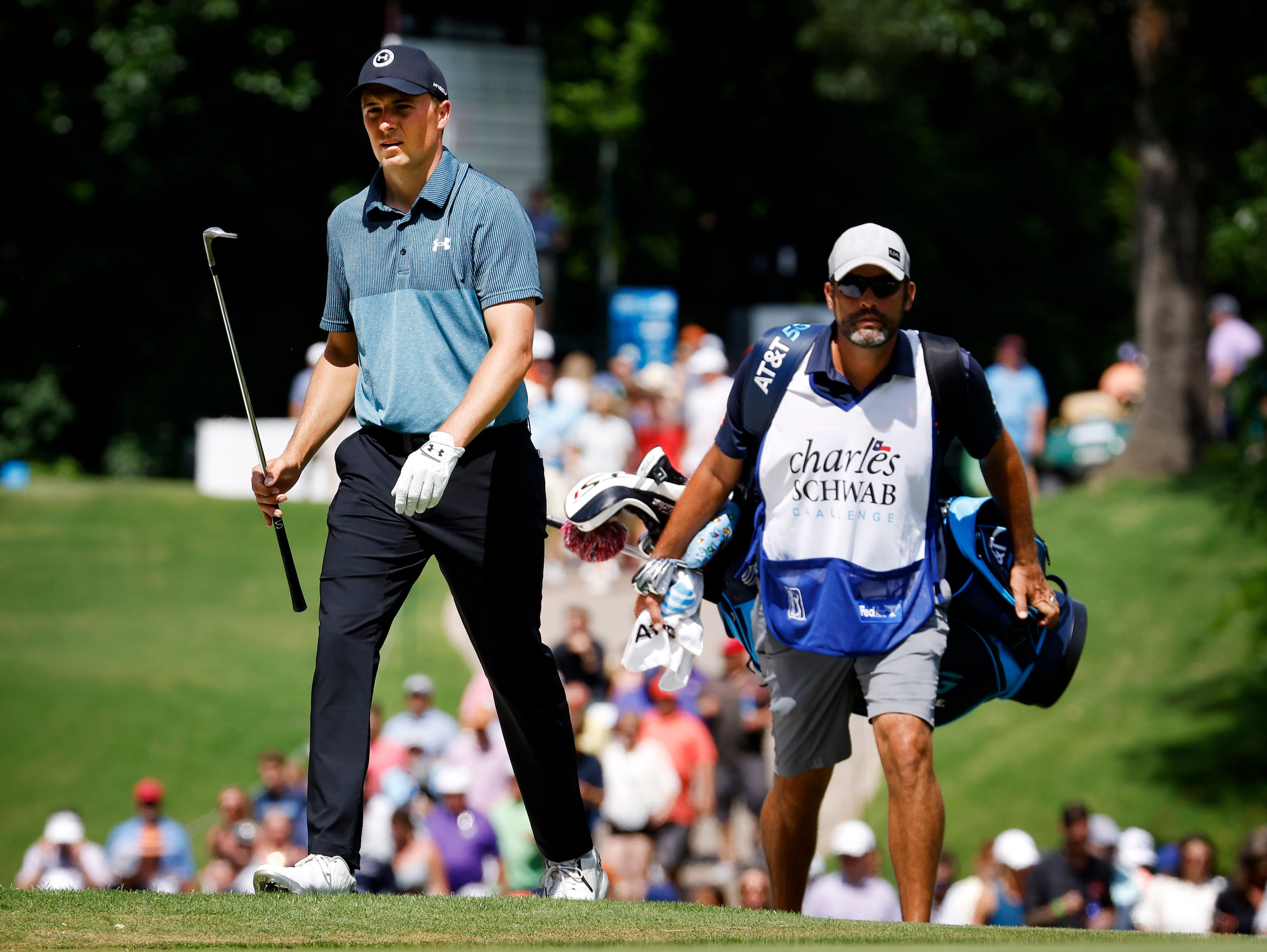 Professional golfer Jordan Spieth of Dallas walks up to the 8th green with his caddie...