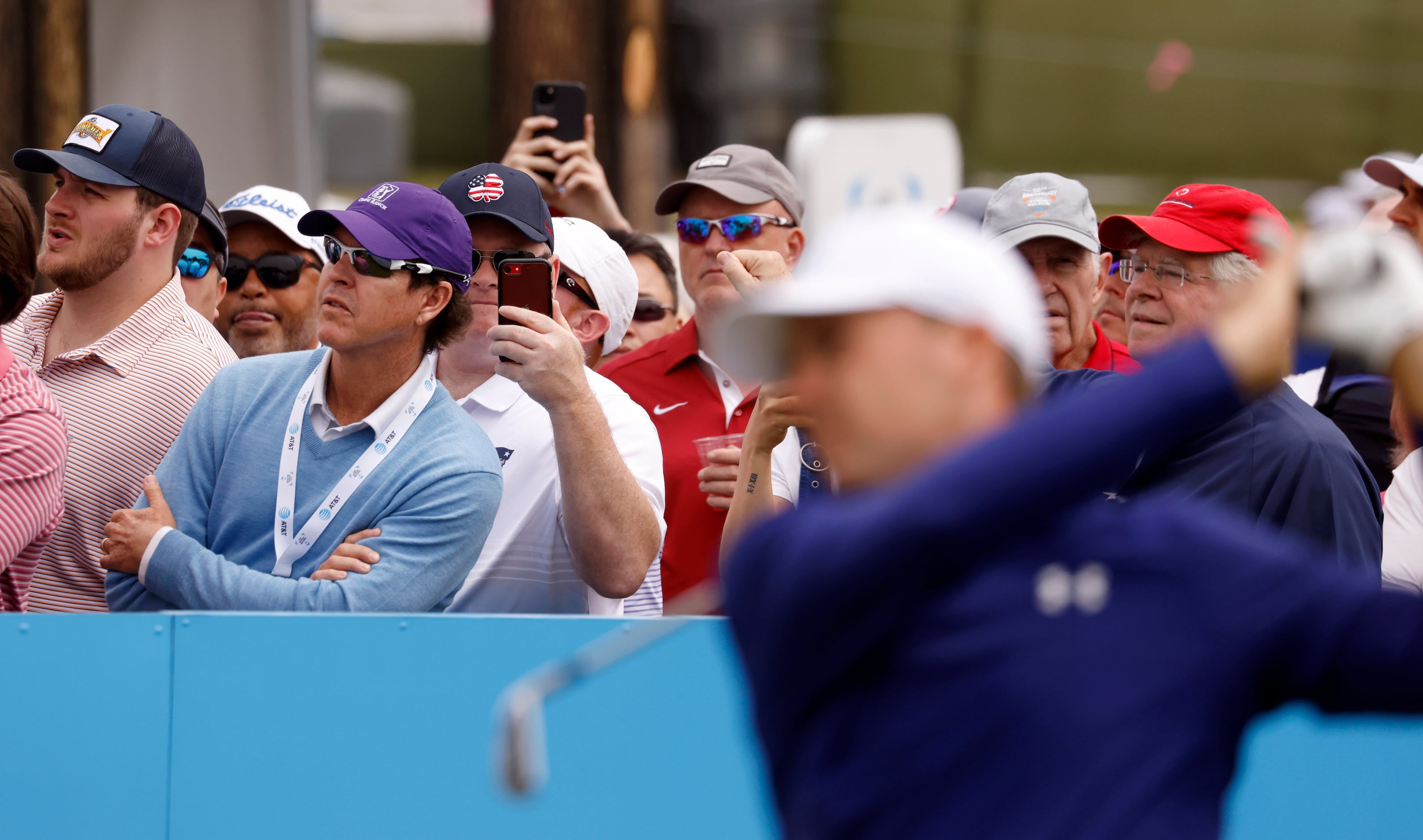 Some fans watch the path of Jordan Spieth's ball as others Fans record Spieth on the 7th tee...