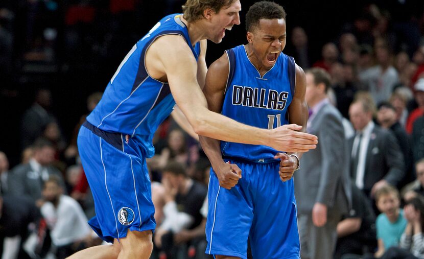 FILE - Mavericks guard Yogi Ferrell, right, and forward Dirk Nowitzki react after Ferrell...