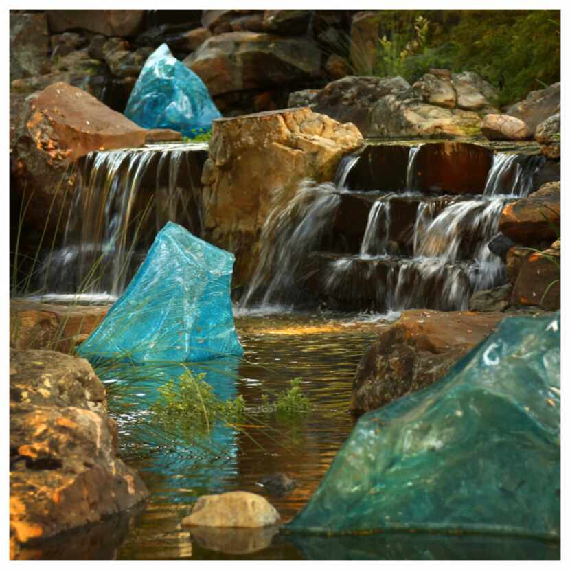 Chihuly's Blue Polyvitro Crystals are seen in a stream at the Dallas Arboretum. Photographed...