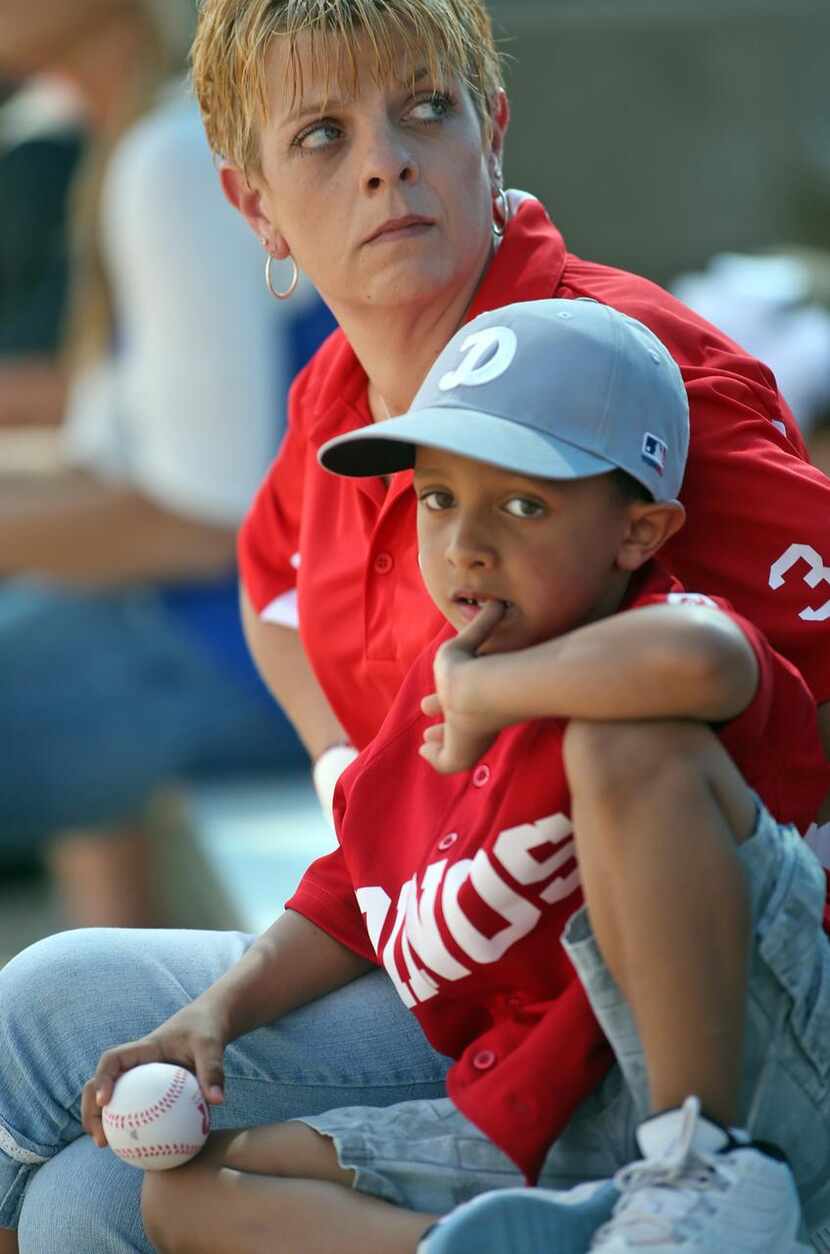 
Brady Carden, 6, with his mother Stacy Carden, watch the home run derby at Mesquite's...