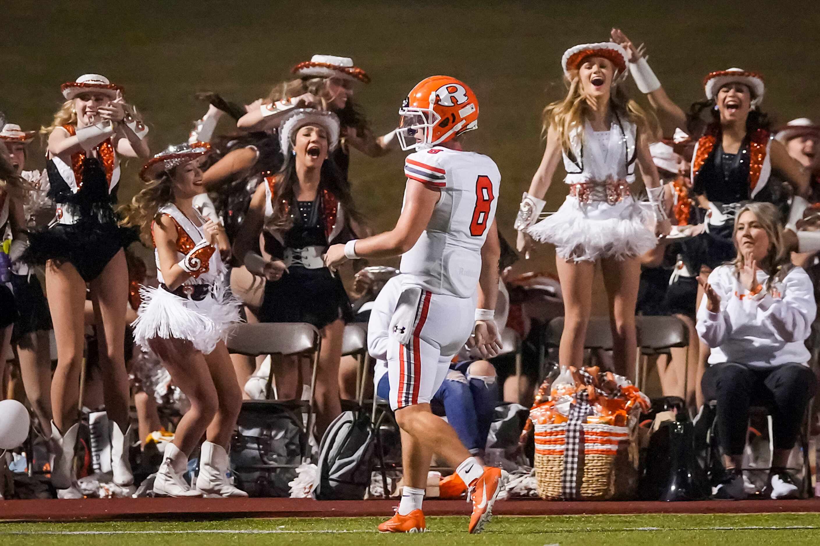 Members of the Rockwall drill team cheer quarterback Braedyn Locke (8) after he scored on a...
