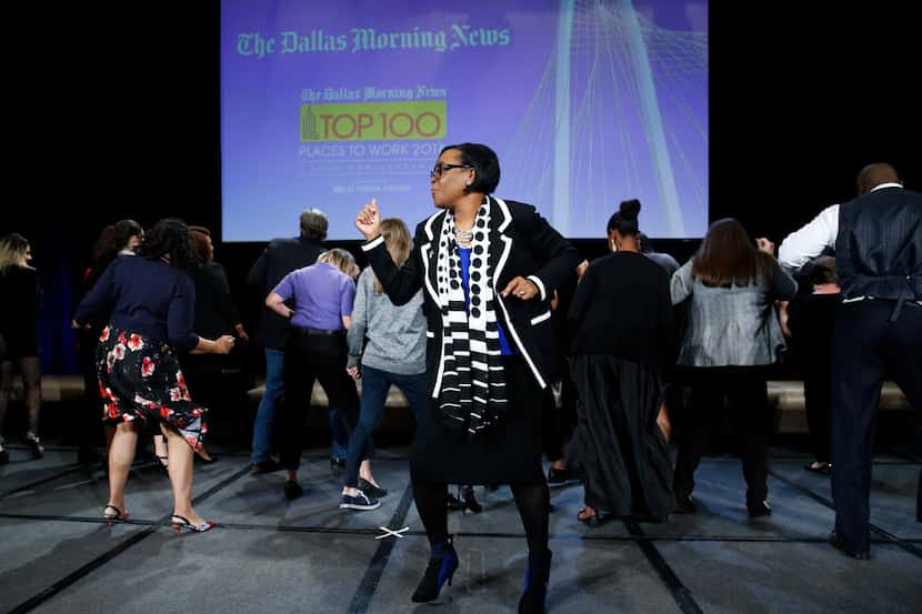 Dallas Mavericks CEO Cynthia Marshall dances with people from the luncheon during her...
