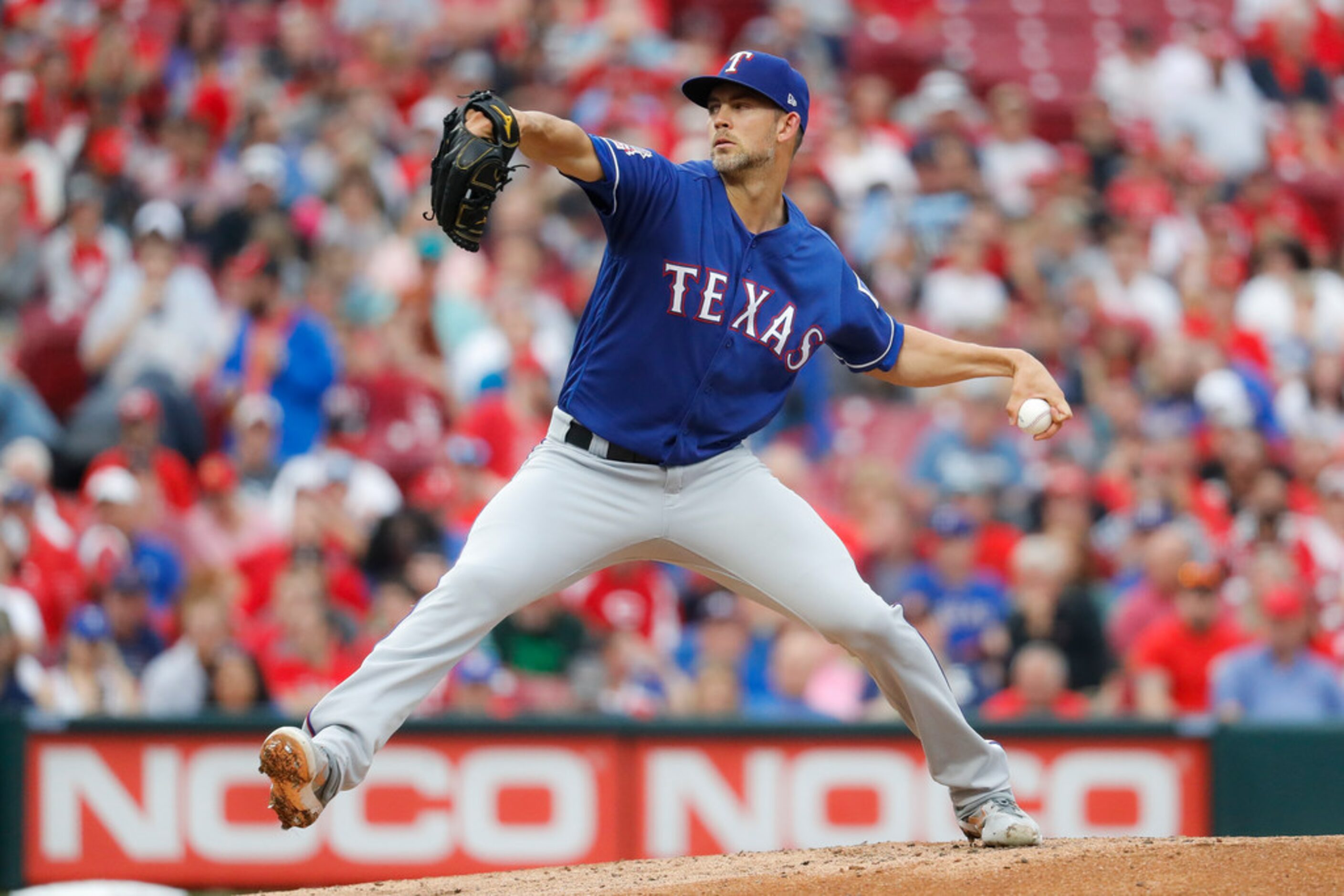 Texas Rangers starting pitcher Mike Minor throws during the first inning of the team's...