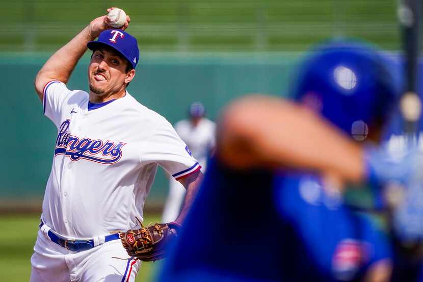Texas Rangers pitcher Derek Law pitches during the third inning of a spring training game...