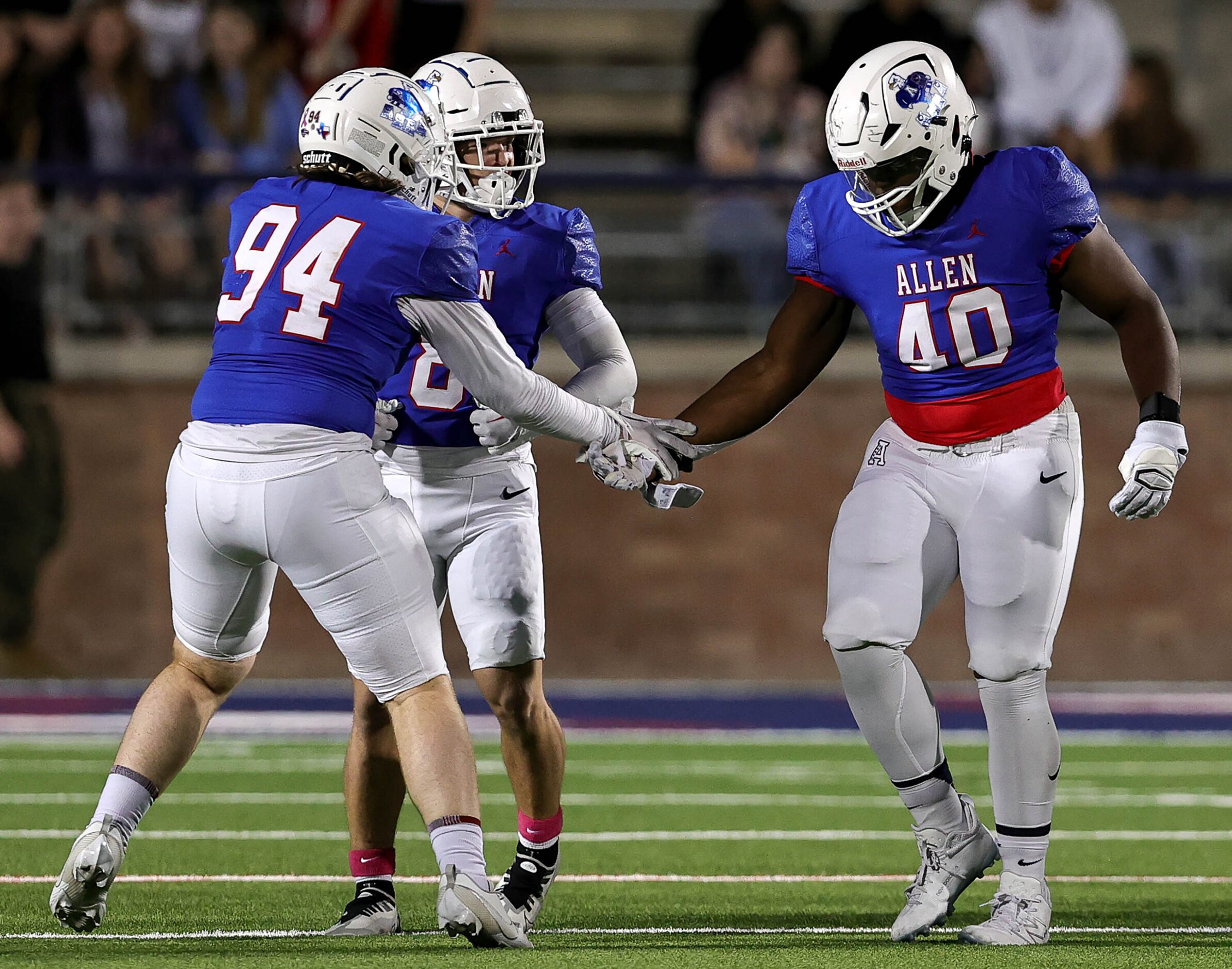 Allen defensive lineman Nathan Marsh (40) celebrates with defensive lineman Mason Smith (94)...