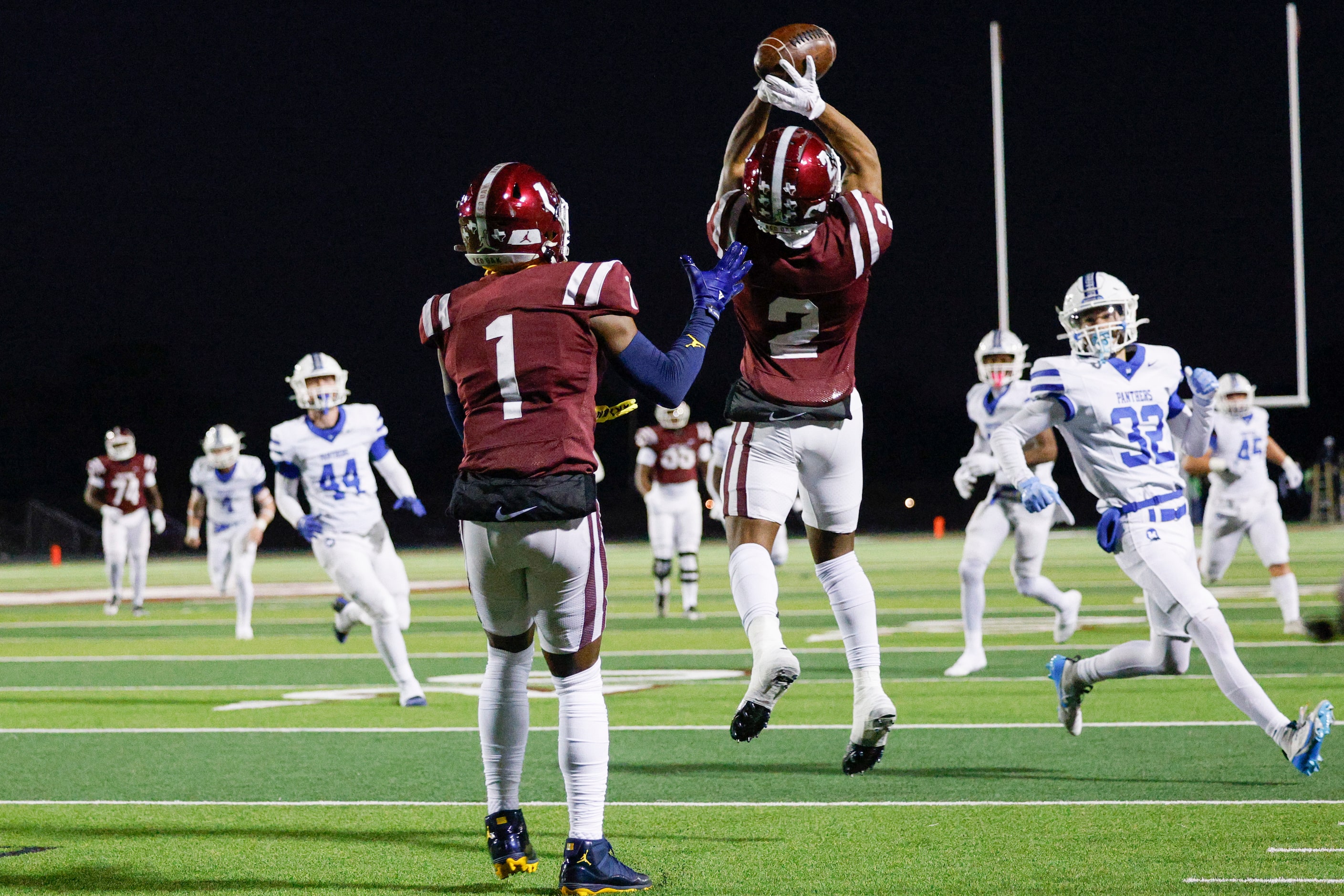 Red Oak wide receiver Taz Williams Jr. (1) watches as wide receiver Brayden Robinson (2)...