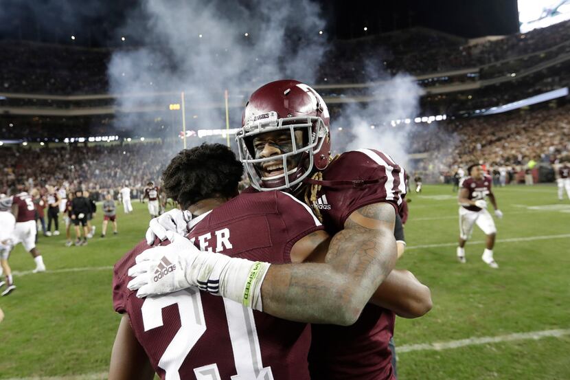 FILE - In this Nov. 24, 2018, file photo, Texas A&M wide receiver Kendrick Rogers, right,...