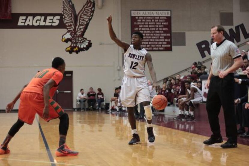 
Rowlett junior Michael Kolawole, directing his team’s offense against Garland Naaman...