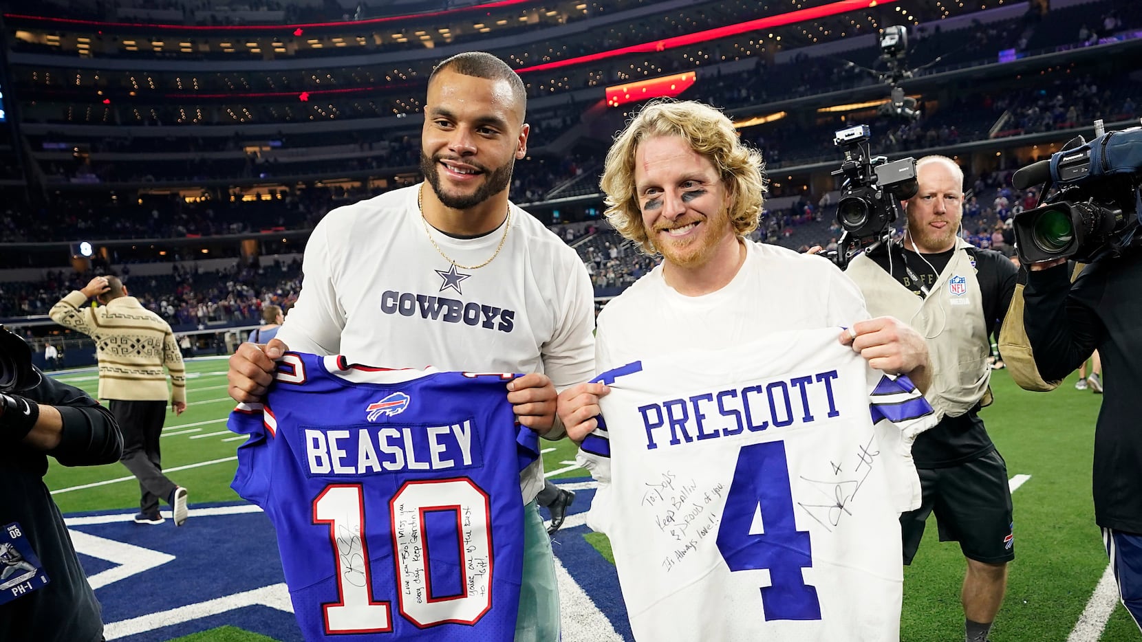 Dallas Cowboys quarterback Dak Prescott (left) exchanges jersey with Buffalo Bills wide...