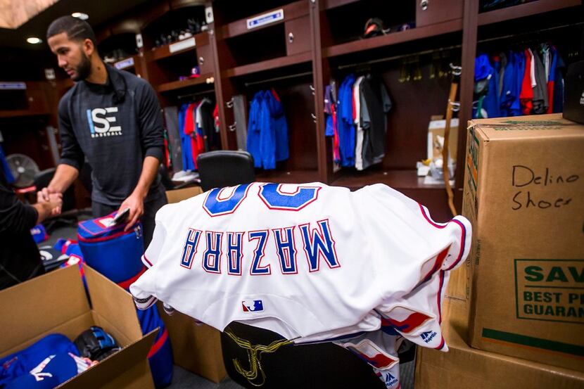 Texas Rangers outfielder Nomar Mazara cleans out his locker at Globe Life Park on Tuesday,...