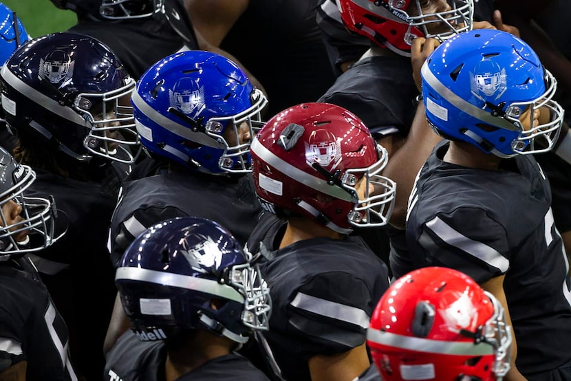 Players listen to a coach during the third day of The Opening at The Star on Monday, July 2,...