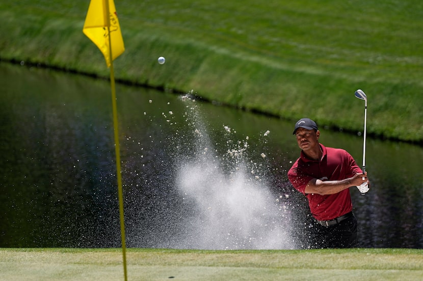 Tiger Woods hits from the bunker on the 15th hole during final round at the Masters golf...