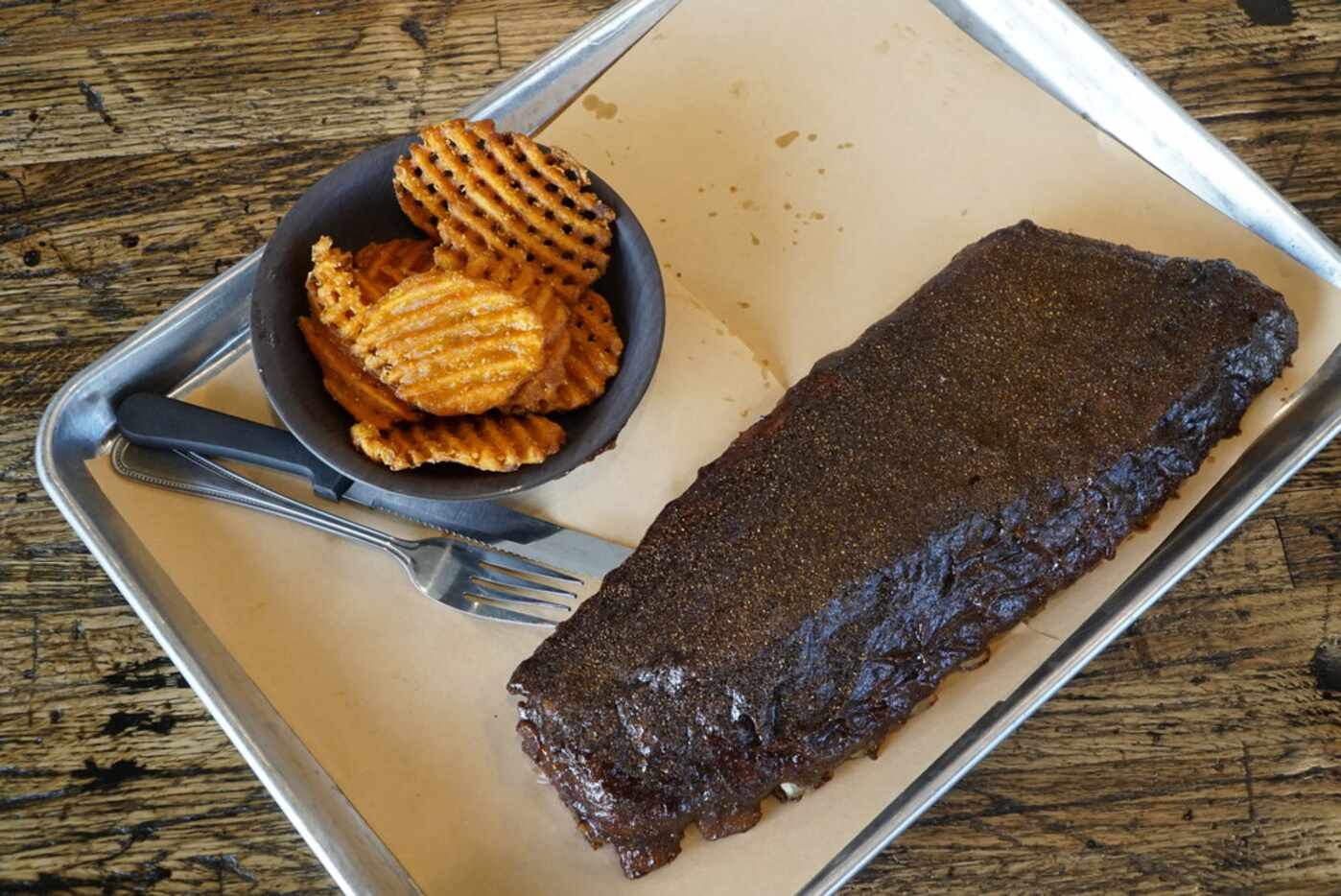 The Full Rack Apple Smoked Texas Hot Ribs with Sweet Potato Fries at the Cookshack in Fort...