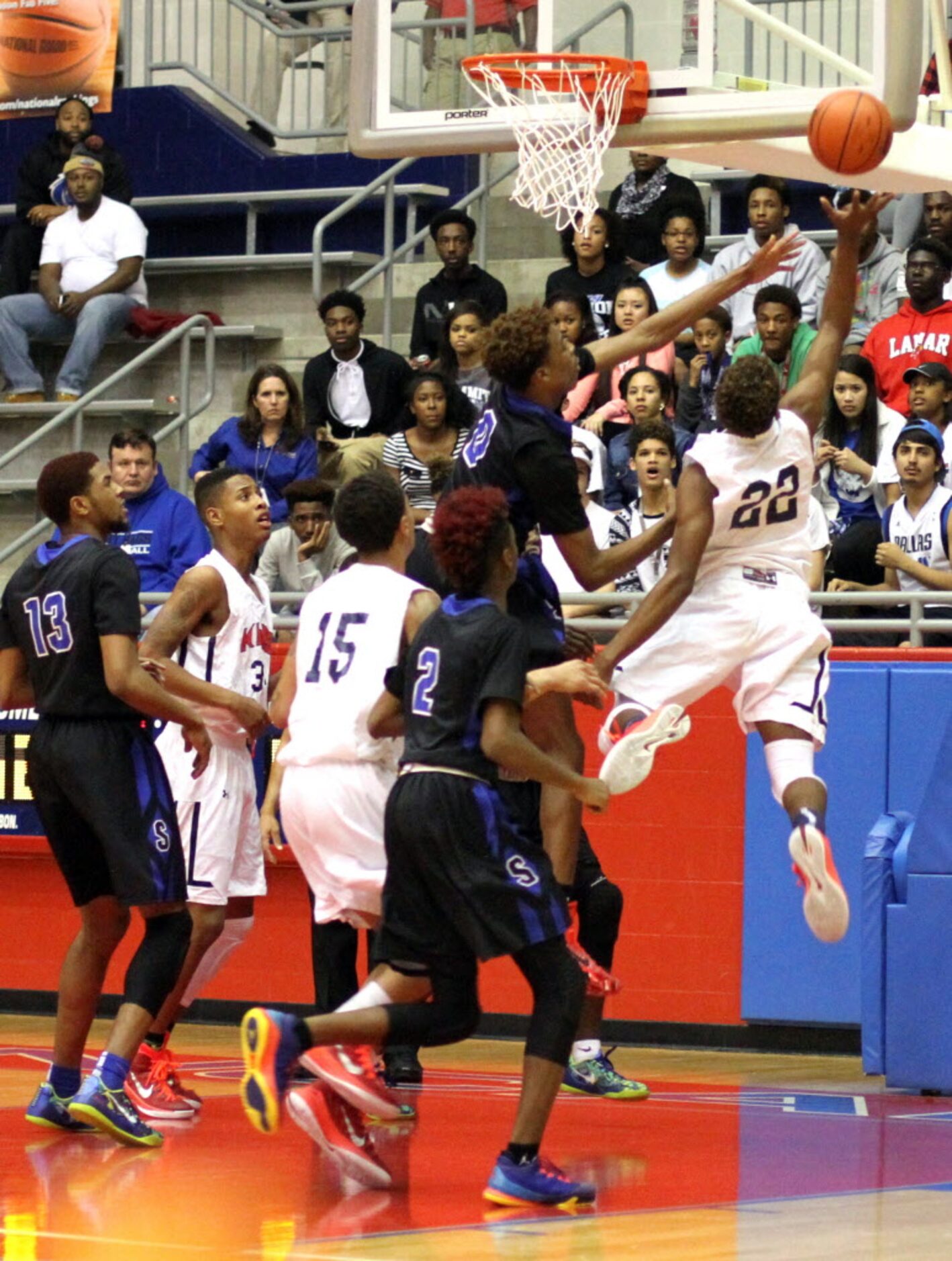 Dallas Kimball forward Kedarian Jones (22) flies to the basket as he is defended by...