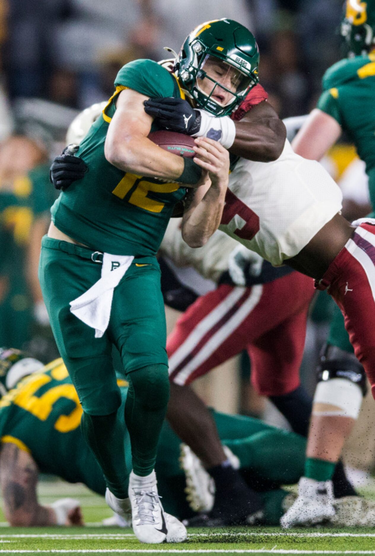 Baylor Bears quarterback Charlie Brewer (12) is tackled by Oklahoma Sooners linebacker...