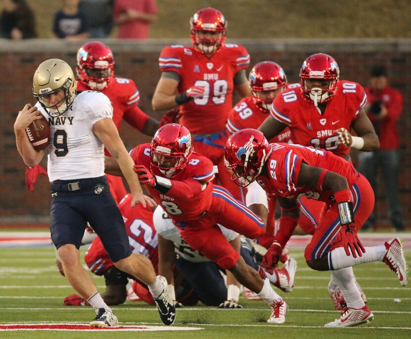 Navy quarterback Zach Abey (9) breaks free for a long run from scrimmage, leaving almost the...