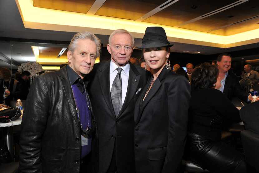 Michael Douglas and Catherine Zeta-Jones with Dallas Cowboys owner Jerry Jones in the Jones...