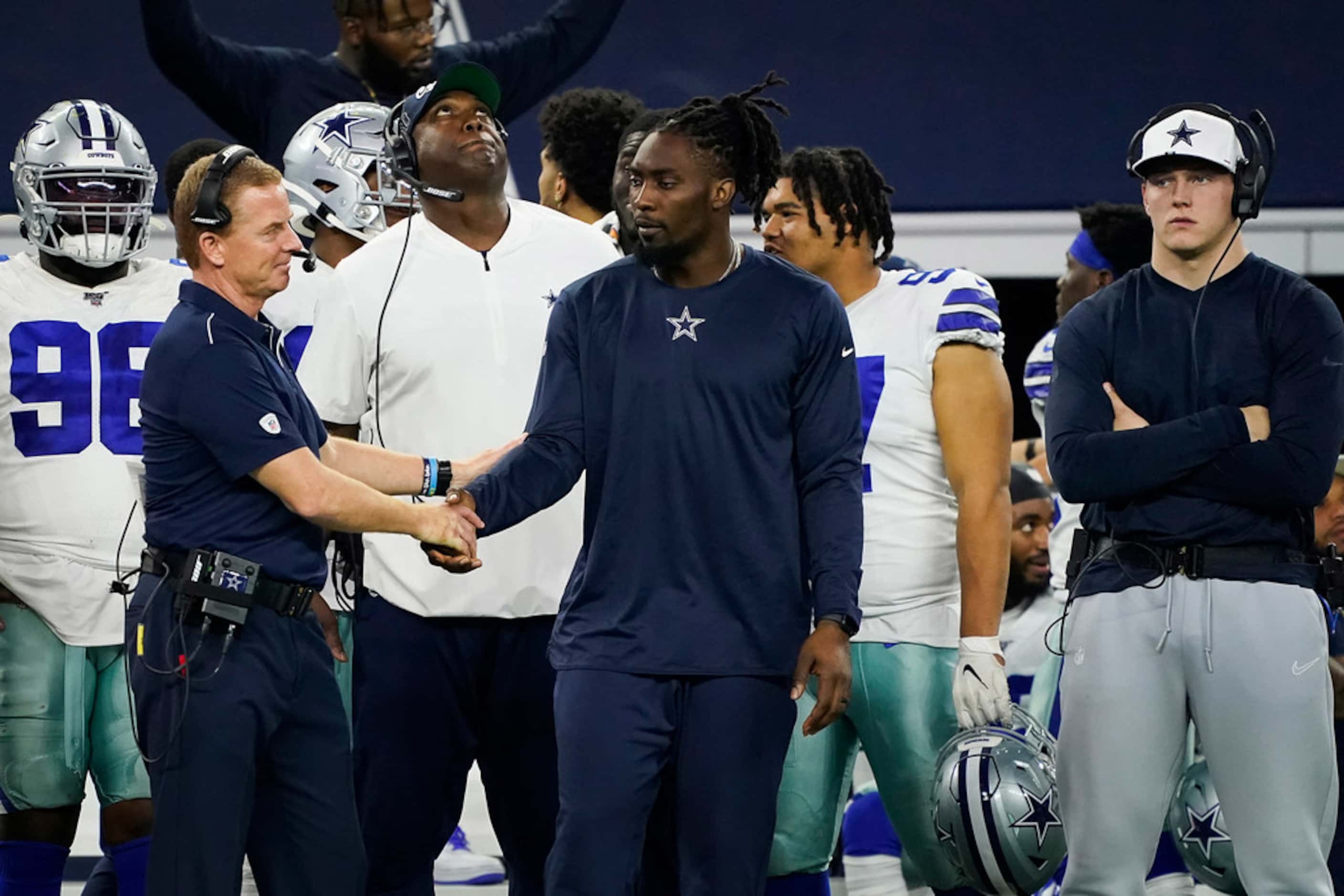 Dallas Cowboys head coach Jason Garrett shakes hands with defensive end Demarcus Lawrence on...