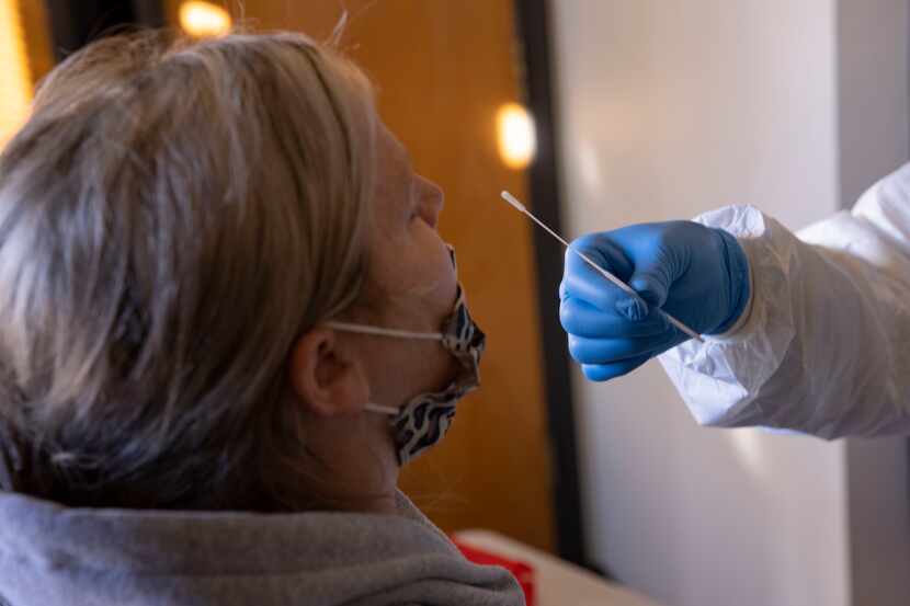 Bethany Barberee (left) is swabbed by Crystal Baker with On Time Mobile Phlebotomist during...