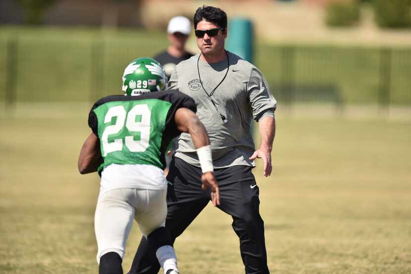 University of North Texas head coach Seth Littrell stands in as a defensive back as wide...