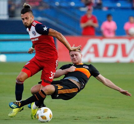 FC Dallas forward Maximiliano Urruti (37) gets hooked by Houston Dynamo defender Adam...