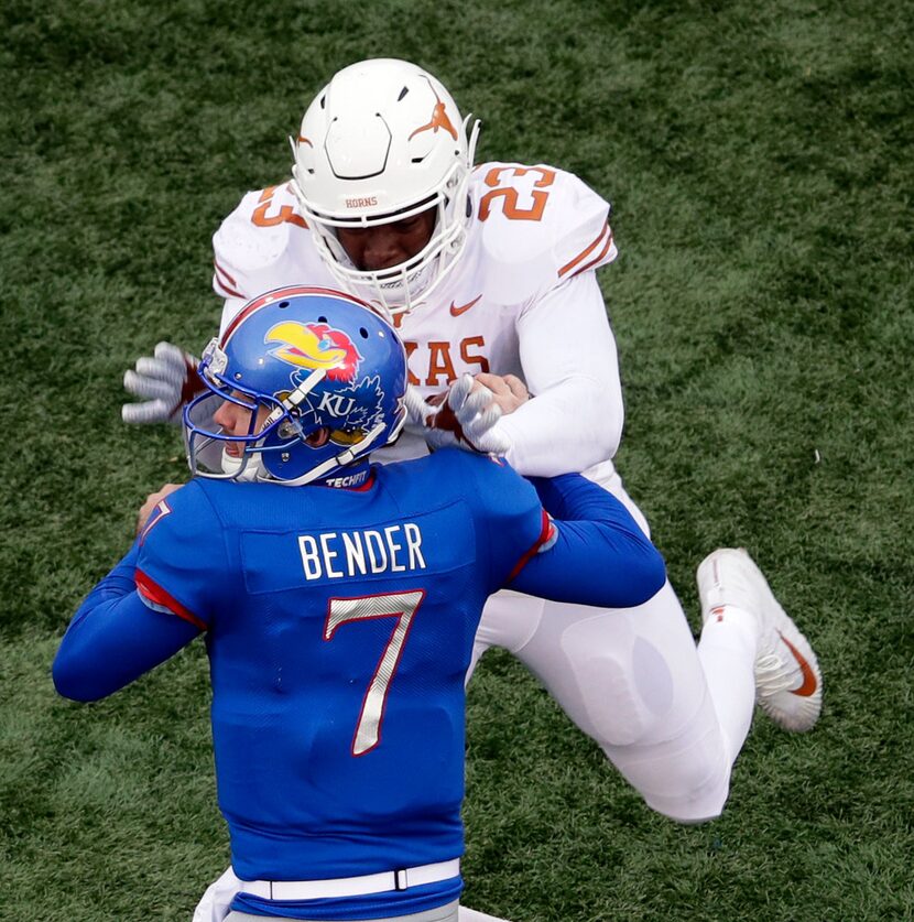 Texas linebacker Jeffrey McCulloch (23) forces a fumble by Kansas quarterback Peyton Bender...