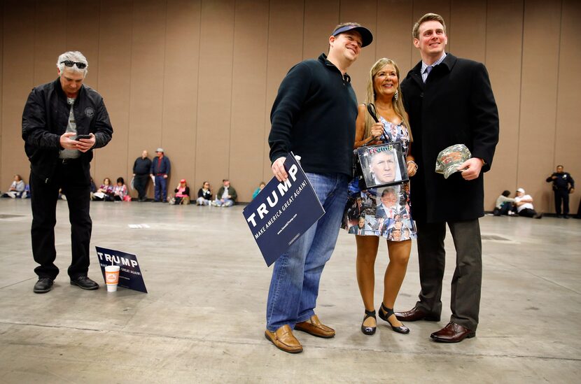 Barbara Tomasino of Plano posed for a photo in her Donald Trump dress with fellow supporters...