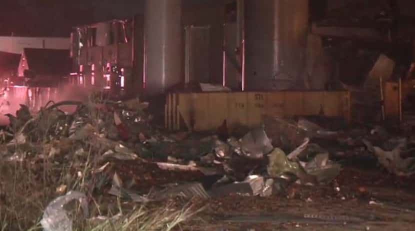 Debris litters an area near where an explosion occurred at a manufacturing plant Friday...