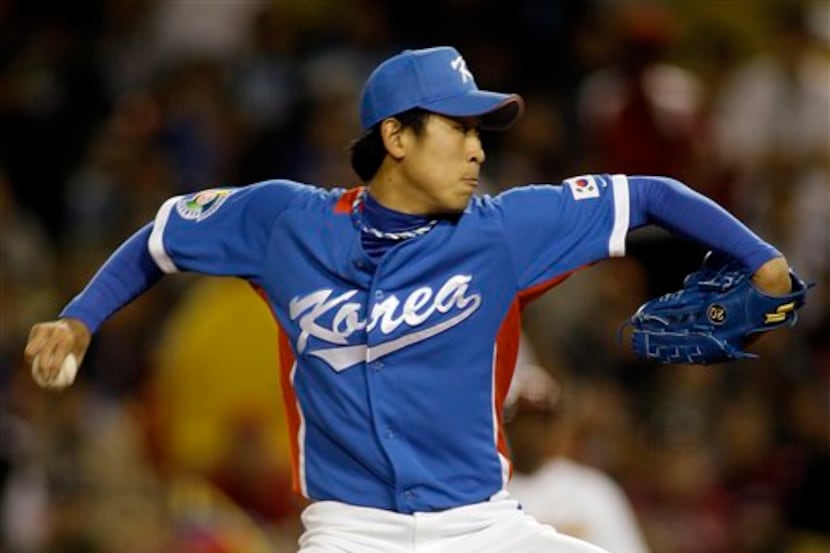South Korea's starter Yoon Suk-min pitches against Venezuela in their semifinal game at the...