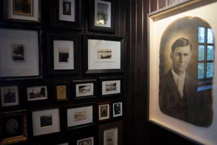 Halfway up one of the staircases at Merchant House, a wall is cluttered with photos. Who's...
