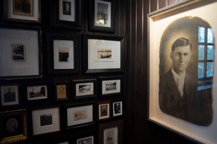 Halfway up one of the staircases at Merchant House, a wall is cluttered with photos. Who's...