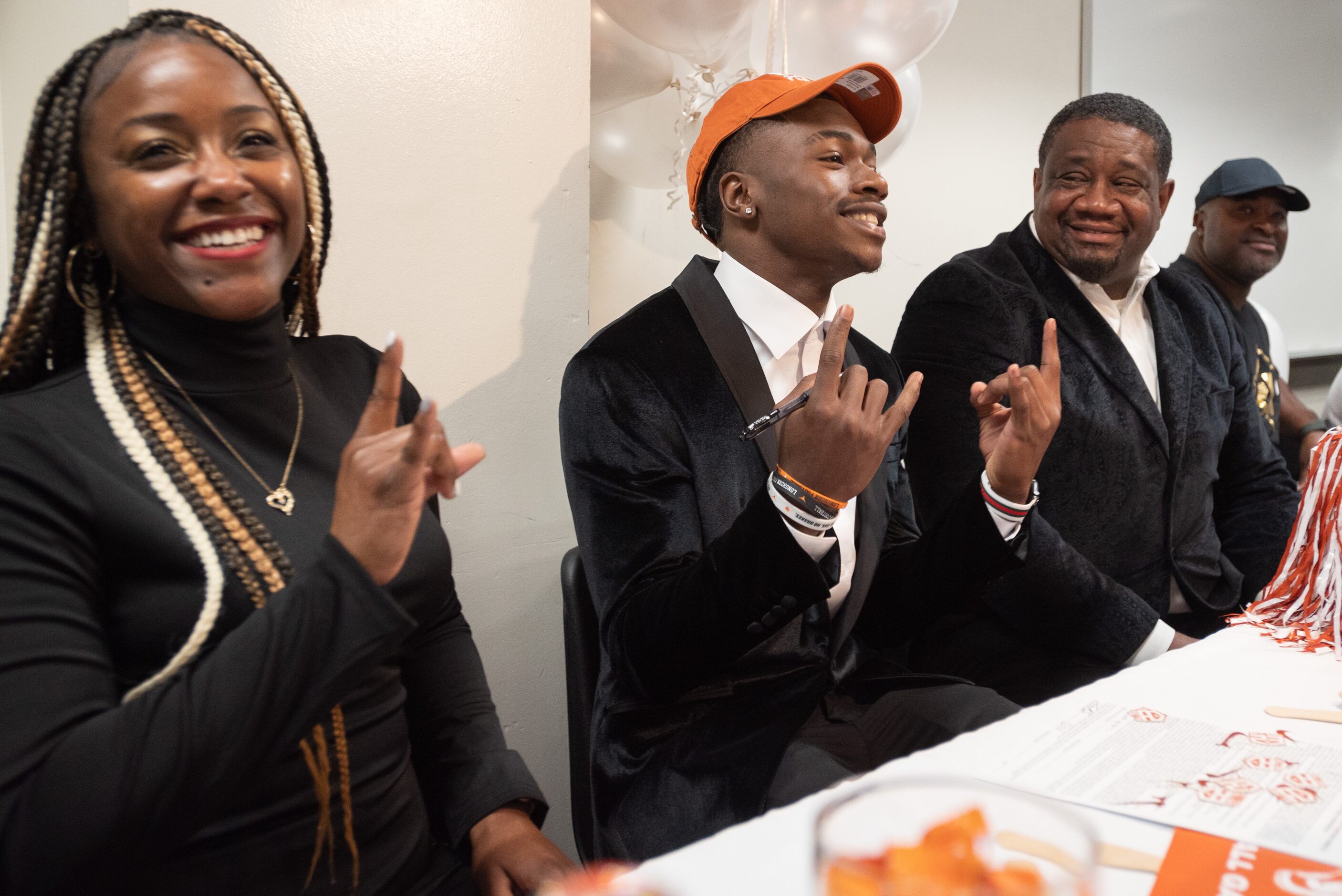 DeSoto high school football player Johntay Cook II shows the Texas hand sign after signing...