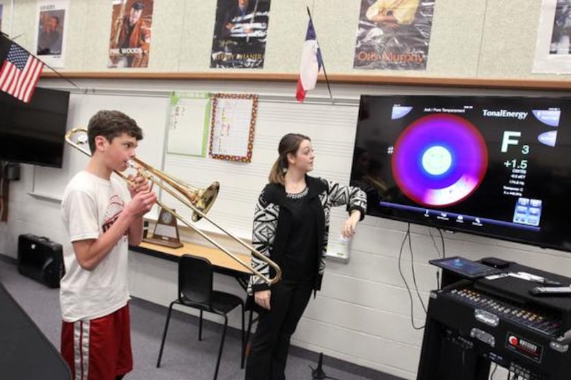 
Student Jack Wilson and teacher Anna Lee Pomponio use an iPad application in band class at...