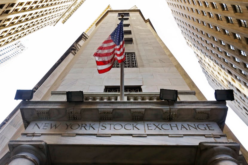 The American flag flies above the Wall Street entrance to the New York Stock Exchange....