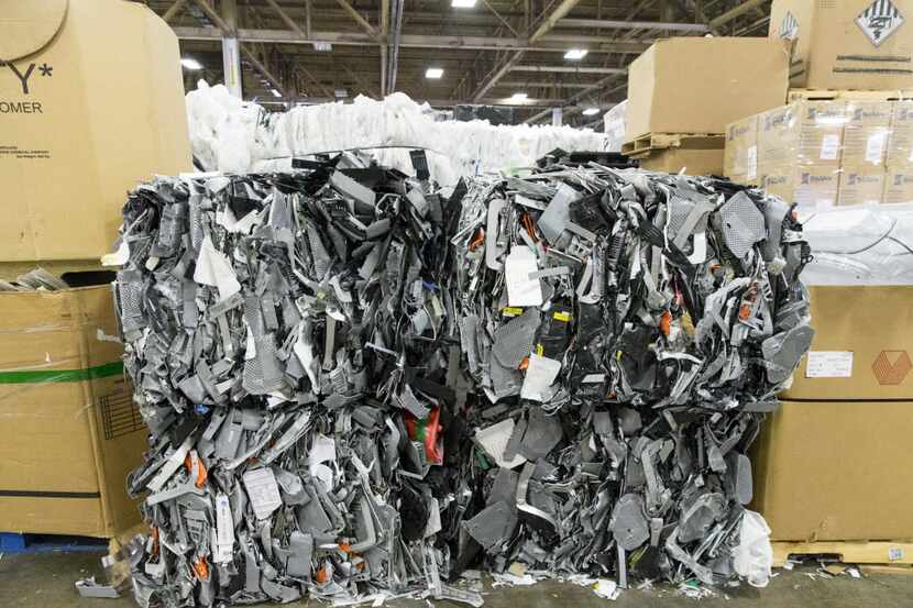 Bales of plastic stacked up in the Texas Recycling plant on July 27 in Dallas. (Ting...