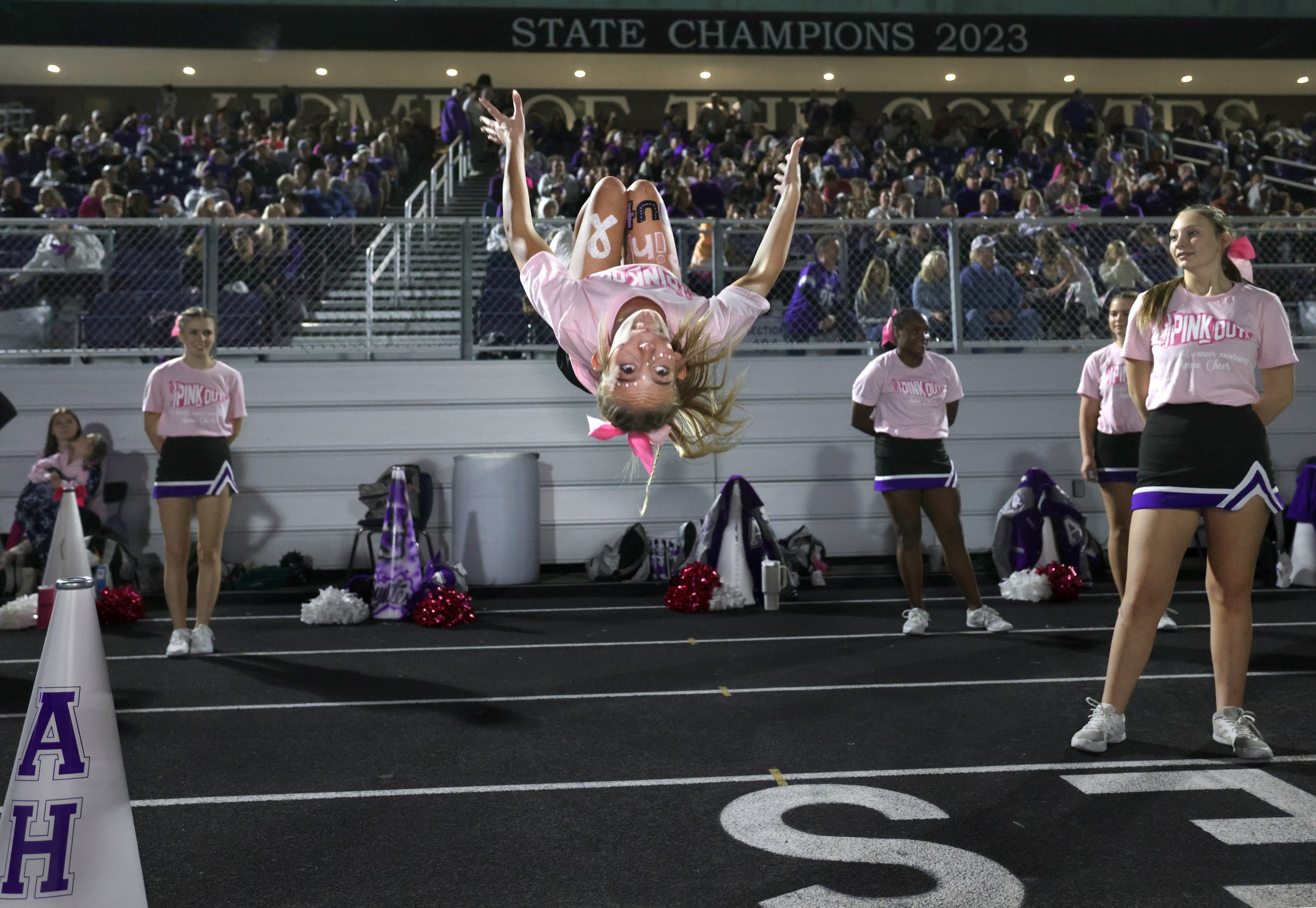 Anna cheerleader Isabella Gilmore does a backflip during the Prosper Walnut Grove High...