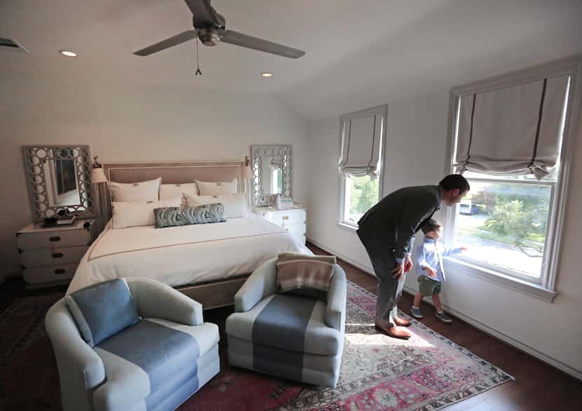 Tony Ruggeri and his son Michael look out the window in the master bedroom of their home at...