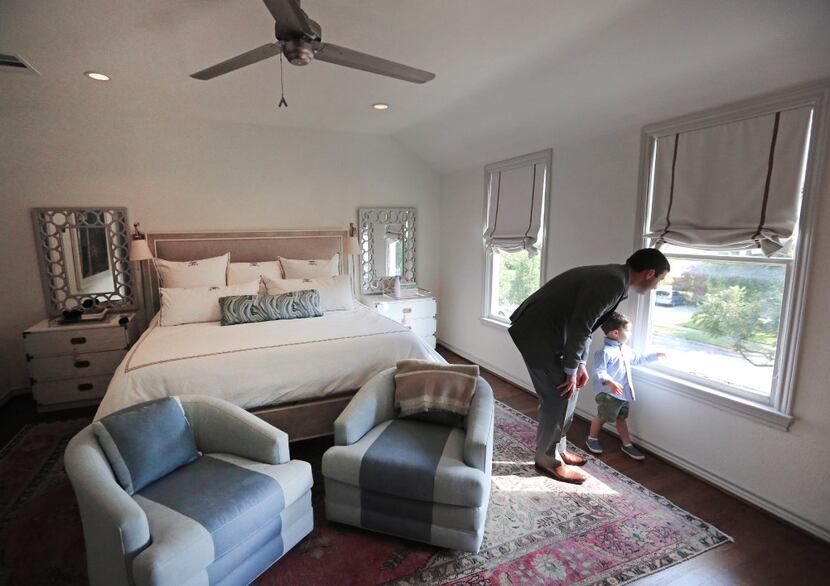 Tony Ruggeri and his son Michael look out the window in the master bedroom of their home at...
