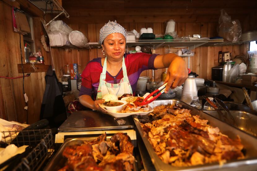 Josephine Cook prepares a plate of food at Old Rooster Creek Filipino Asian/American BBQ in...
